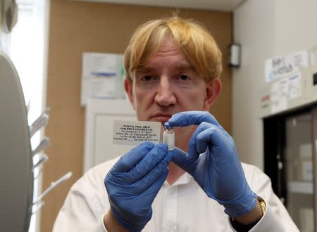 Professor Adrian Hill, Director of the Jenner Institute, and Chief Investigator of the trials, holds a phial containing the Ebola vaccine at the Oxford Vaccine Group Centre for Clinical Vaccinology and Tropical Medicine (CCVTM) in Oxford, southern England September 17, 2014. REUTERS/Steve Parsons/Pool