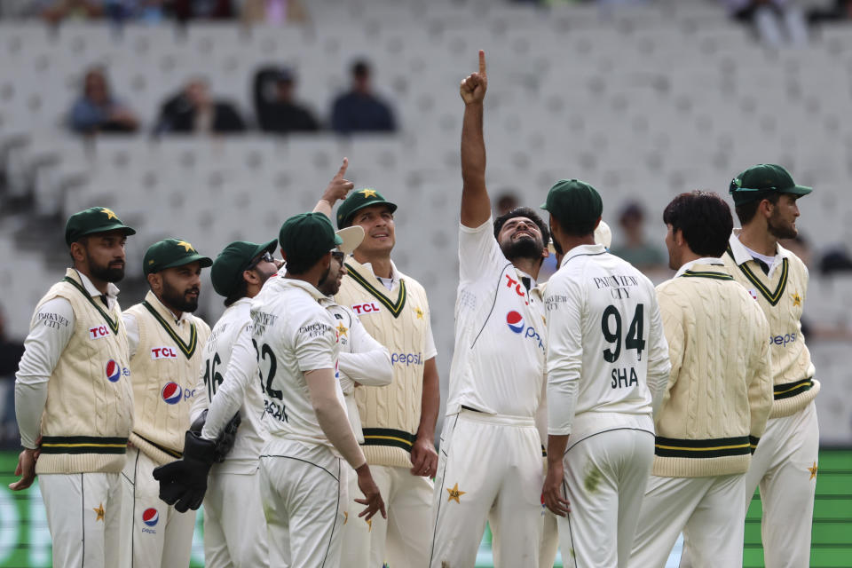 Pakistan's Aamer Jamal, center, points up after taking the wicket of Australia's Australia's Steve Smith during their cricket test match in Melbourne, Tuesday, Dec. 26, 2023. (AP Photo/Asanka Brendon Ratnayake)