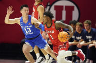 Utah guard David Jenkins Jr. (1) drives as BYU guard Alex Barcello (13) defends in the first half during an NCAA college basketball game Saturday, Nov. 27, 2021, in Salt Lake City. (AP Photo/Rick Bowmer)