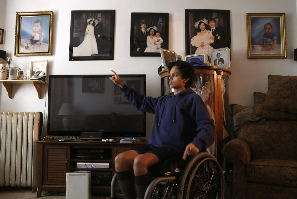 FILE - Jonathan Annicks sits in his wheelchair on June 13, 2016, and recalls the events that left him paralyzed by a lone gunman outside the family home in Chicago. Six years later Annicks has received a bachelor's degree in communications and media and has become a part-time peer advisor for patients at the same rehabilitation hospital where he was a patient. (AP Photo/Charles Rex Arbogast File)