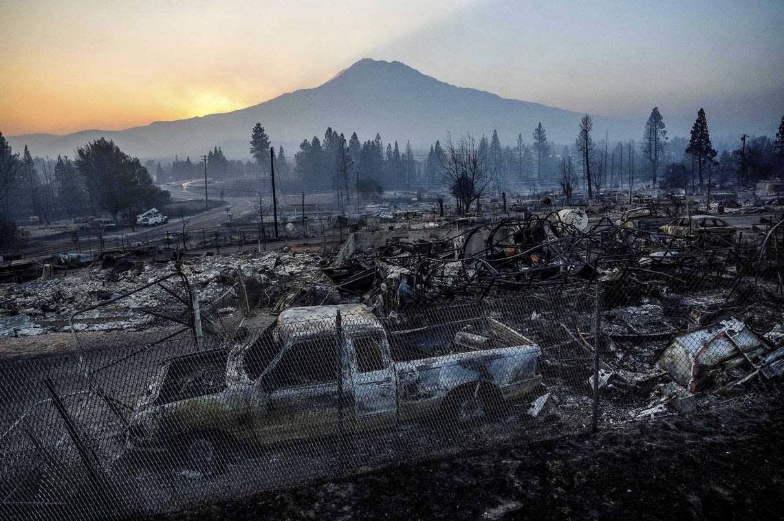 The sun rises over Mount Shasta and homes in Weed destroyed by the Mill Fire in September 2022. Pacific Bell is suing a timber company that operated a mill in Weed, where the deadly 2022 Mill Fire erupted.