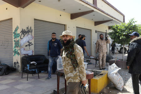 Members of Libyan internationally recognised government forces react during the fighting with Eastern forces at Al-Swani area in Tripoli, Libya April 18, 2019. REUTERS/Ahmed Jadallah