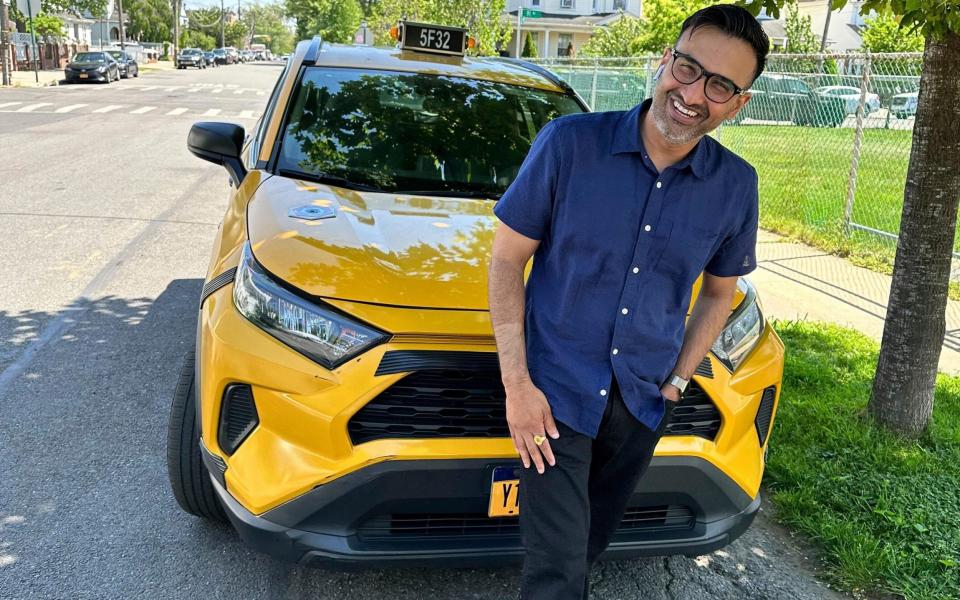 New York City cab driver Sukhcharn Singh with his taxi in Queens - AP