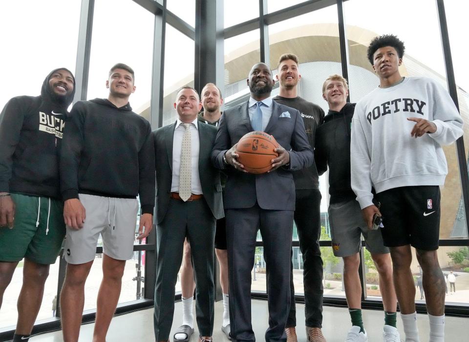 New Milwaukee Bucks head coach Adrian Griffin (center)  with Milwaukee Bucks general manager Jon Horst (left of Griffin) and Milwaukee Bucks players pose for a photo during a press conference at GATHER at Deer District in Milwaukee on Tuesday, June 6, 2023.