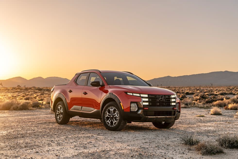 a red car parked in a desert