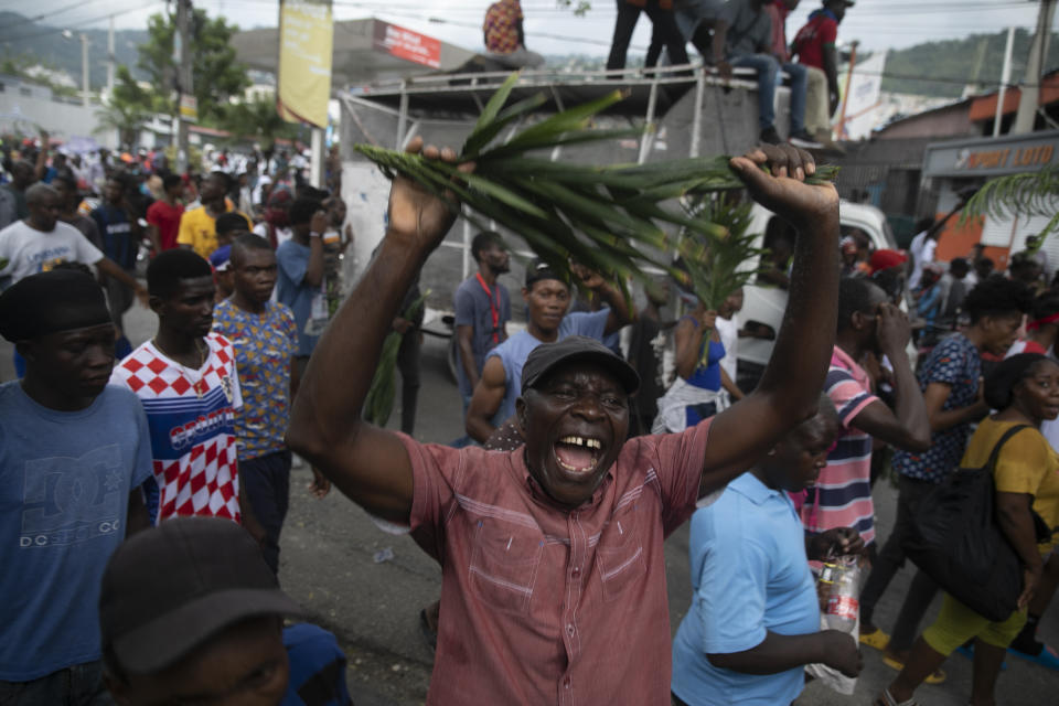 Demonstrators shout during a protest in Port-au-Prince, Haiti, Monday, Aug. 22, 2022. Protesters marched through Haiti's capital and other major cities, blocking roads and shutting down businesses to demand that Prime Minister Ariel Henry step down and call for a better quality of life. (AP Photo/Odelyn Joseph)