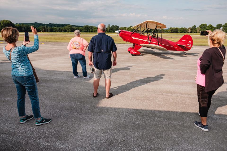 Cooper Winters, 12, (seated in front of plane) taxis in the Hatz biplane owned and operated by flight instructor Ryan Newell (in the rear seat) on Saturday at Harry Clever Field in New Philadelphia. Winters was among 14 students in a nine-week aviation education program offered by Experimental Aircraft Association Chapter 1077.