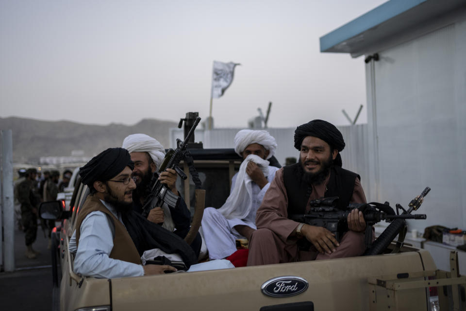 Taliban fighters sit in a pickup truck at the airport in Kabul, Afghanistan, Thursday, Sept. 9, 2021. Some 200 foreigners, including Americans, flew out of Afghanistan on an international commercial flight from Kabul airport on Thursday, the first such large-scale departure since U.S and foreign forces concluded their frantic withdrawal at the end of last month. (AP Photo/Bernat Armangue)