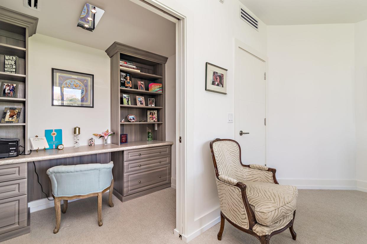 The homeowners carved out space in the primary bedroom for a home office, which can be closed off by pocket doors.