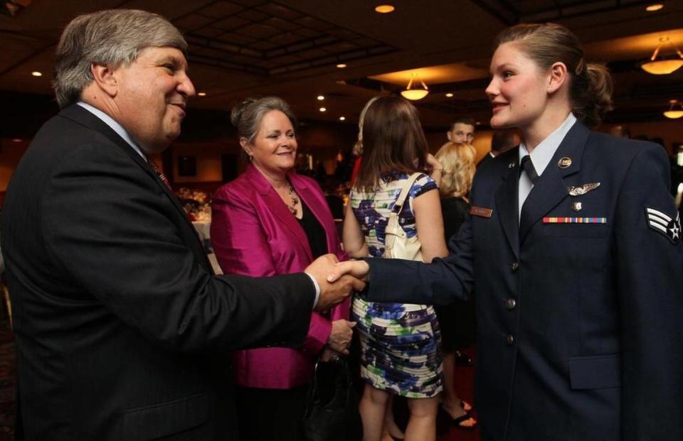 John Lengerman, executive director of the Belleville Chamber of Commerce, greets Senior Airman Emily Mormino of the 932nd A.E.S. at Scott Air Force Base at the 61st annual Belle-Scott Dinner at Fischer’s in Belleville in 2011.