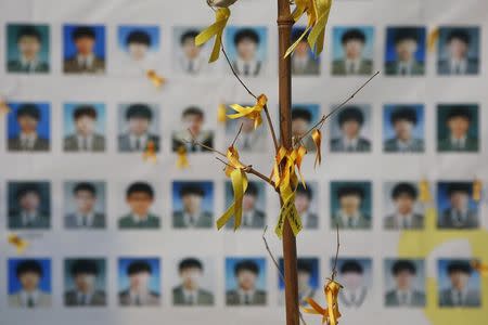 Portraits of students who died in the Sewol ferry disaster are seen behind an art installation dedicated to the victims in central Seoul November 11, 2014. REUTERS/Kim Hong-Ji