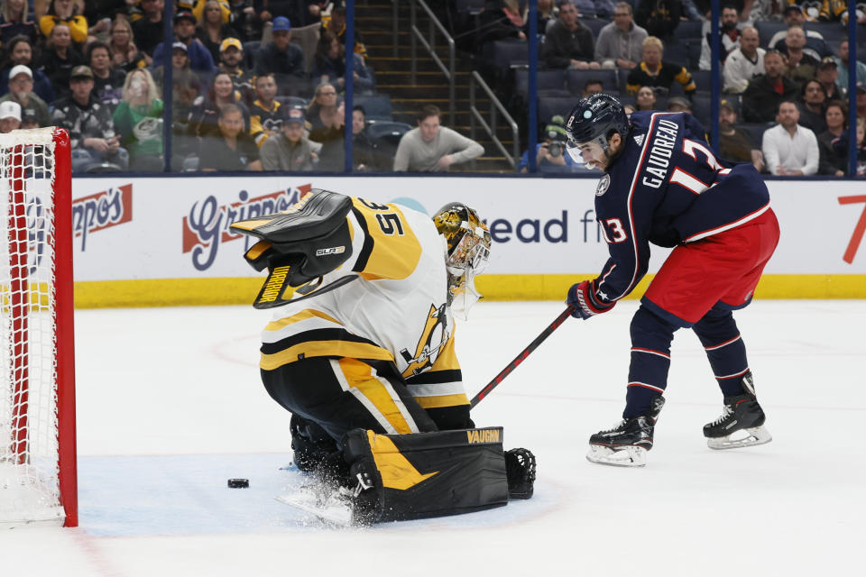 Columbus Blue Jackets' Johnny Gaudreau, right, scores against Pittsburgh Penguins' Tristan Jarry during overtime in an NHL hockey game Thursday, April 13, 2023, in Columbus, Ohio. (AP Photo/Jay LaPrete)