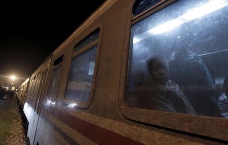 Migrants wait to exit a train at a train station in Sredisce ob Dravi, Slovenia October 17, 2015. REUTERS/Srdjan Zivulovic