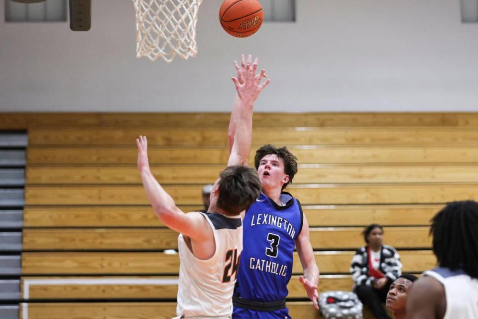 Lexington Catholic’s Tyler Doyle (3) shoots the ball against Frederick Douglass’ Logan Busson during the Knights’ 62-56 win at Frederick Douglass High School on Feb. 14.