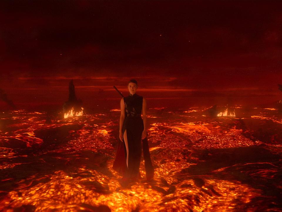 sophon in three body problem, a woman in a black dress with a sword strapped to her back, walking through a sea of lava and flame. she looks threatening and powerful