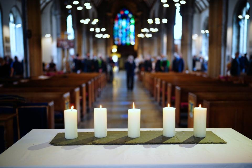 Five lit candles on the altar to remember the five people who were killed by gunman Jake Davison (Ben Birchall/PA) (PA Wire)