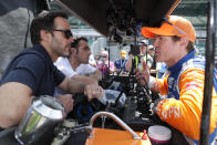 FILE - NASCAR driver Jimmy Johnson, left, and Indycar driver Scott Dixon, right, talk during practice for the Indianapolis 500 IndyCar auto race at Indianapolis Motor Speedway in Indianapolis, in this May 16, 2019, file photo. Three-time Indy 500 champion Dario Franchitti sits, second from left. The IndyCar season begins with three new drivers, including seven-time NASCAR champion Jimmie Johnson. (AP Photo/Michael Conroy, File)
