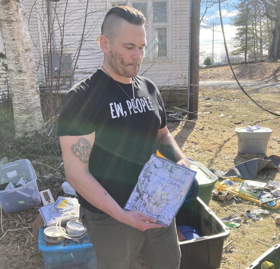 Ron Woodall, with a Father's Day card from his son, damaged in the fire.