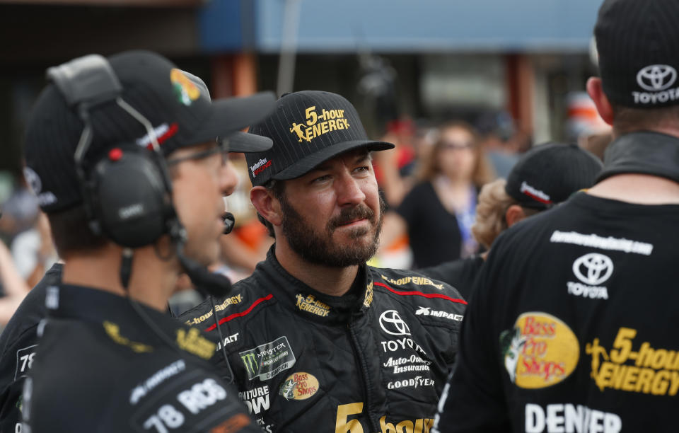 Martin Truex Jr. watches times during qualifications for a NASCAR Cup Series auto race at Michigan International Speedway in Brooklyn, Mich., Friday, Aug. 10, 2018. (AP Photo/Paul Sancya)