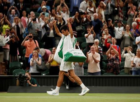 Tennis - Wimbledon - All England Lawn Tennis and Croquet Club, London, Britain - July 13, 2018 Serbia's Novak Djokovic as he walks off court after his semi final match against Spain's Rafael Nadal was stopped due to the time REUTERS/Andrew Boyers