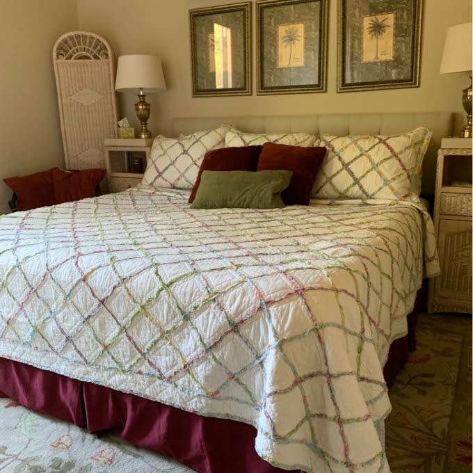 reviewer image of the quilt and matching pillow cases on a bed