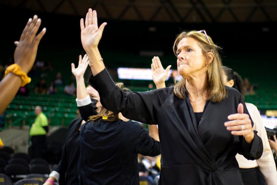 Missouri coach Robin Pingeton high-fives her players before a game against Baylor on Saturday in Waco, Texas.