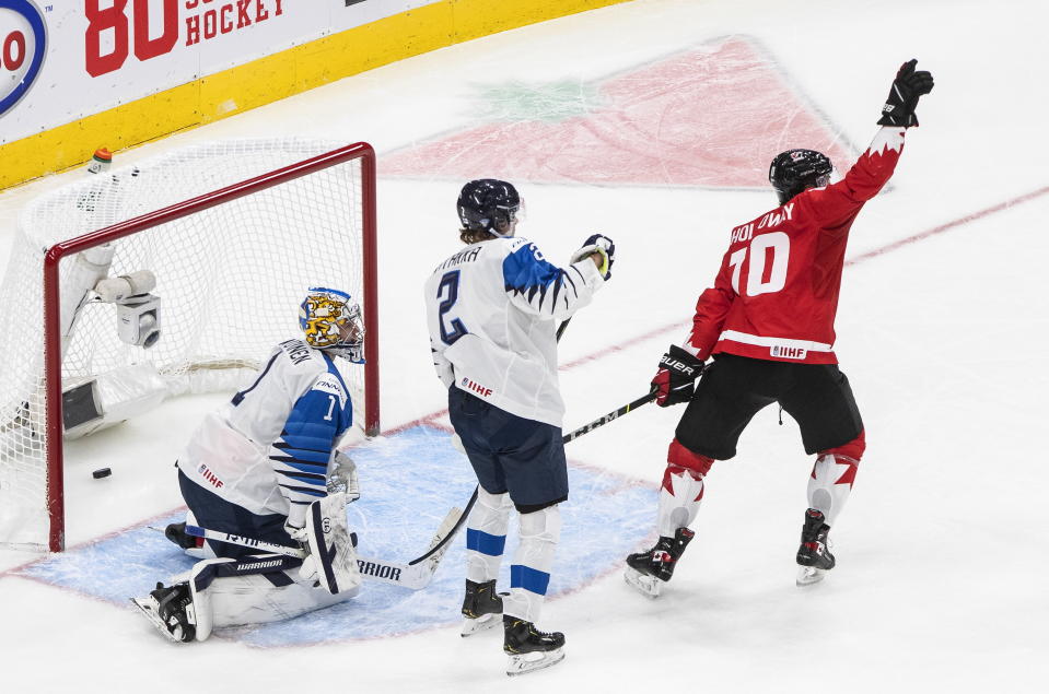 Canada's Dylan Holloway (10) reacts as the puck goes in past Finland goalie Kari Piiroinen (1) as Santeri Hatakka (2) watches during the second period of an IIHF World Junior Hockey Championship game Thursday, Dec. 31, 2020, in Edmonton, Alberta. (Jason Franson/The Canadian Press via AP)