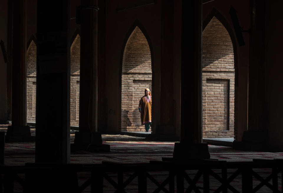 A Kashmiri woman looks inside the Jamia Masjid, or the grand mosque in Srinagar, Indian controlled Kashmir, Nov. 13, 2021. The mosque has remained out of bounds to worshippers for prayers on Friday – the main day of worship in Islam. Indian authorities see it as a trouble spot, a nerve center for anti-India protests and clashes that challenge New Delhi’s sovereignty over disputed Kashmir. For Kashmiri Muslims it is a symbol of faith, a sacred place where they offer not just mandatory Friday prayers but also raise their voice for political rights. (AP Photo/Mukhtar Khan)