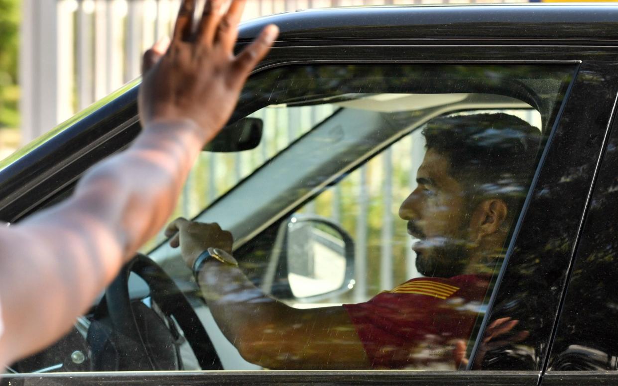 Luis Suarez laves Barcelona as a fan waves goodbye - AFP