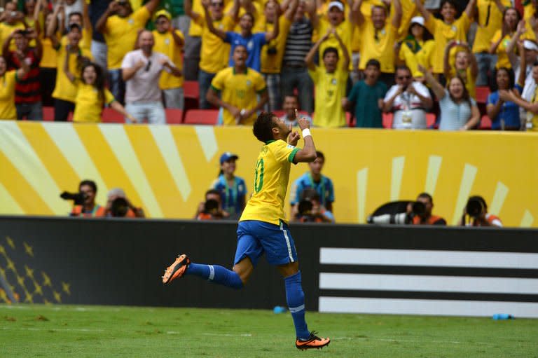 Brazil's forward Neymar celebrates after scoring against Japan in Brasilia on June 15, 2013