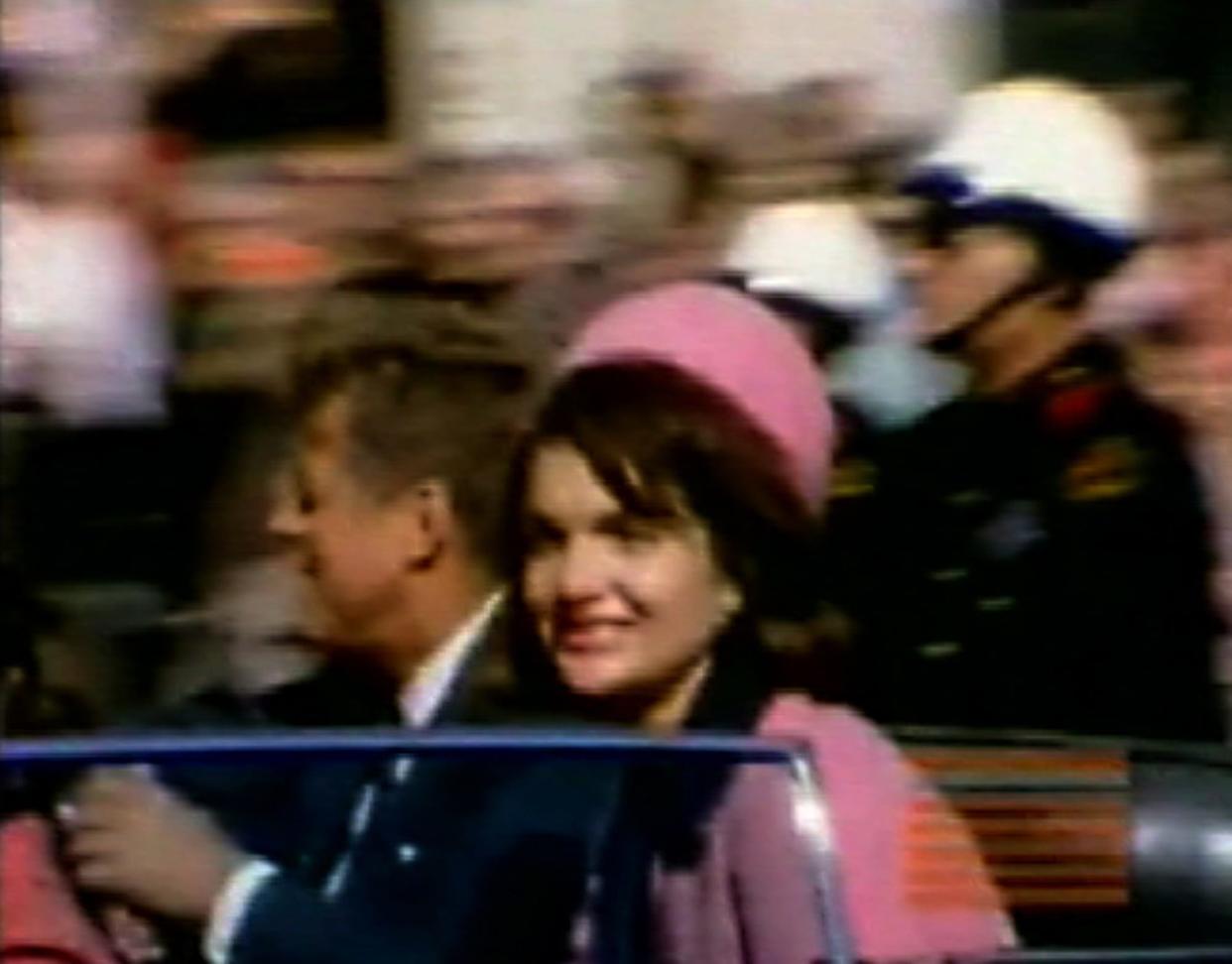 This image made from a home movie released in 2007 by the Sixth Floor Museum at Dealey Plaza shows former President John F. Kennedy, left, and his wife Jacqueline moments before his assassination in Dallas on Nov. 22, 1963. The silent, 8 mm color film was made by amateur photographer George Jefferies.