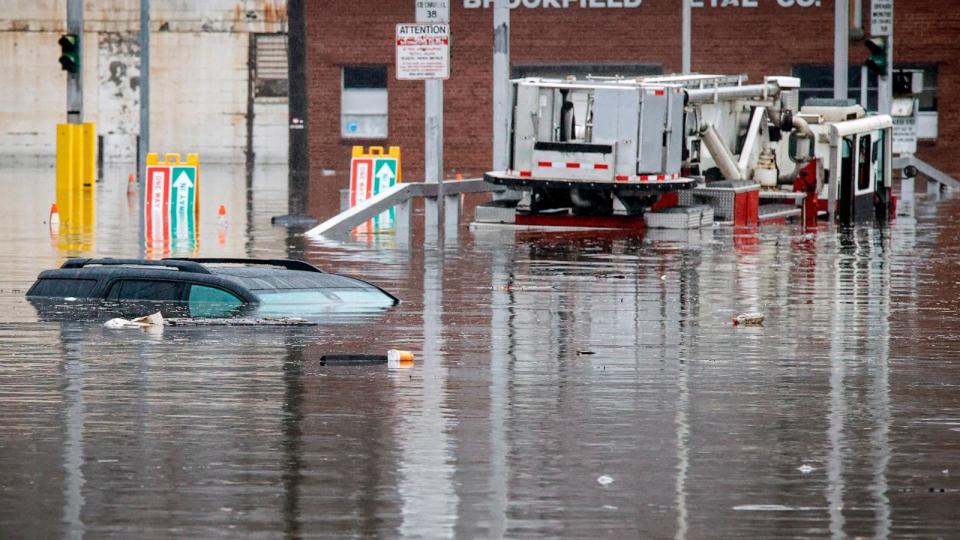 PHOTO: A car and a fire truck are submerged in flood water on Lamont Street after a large rainstorm on Dec. 18, 2023, in Elmsford, New York.  (Kena Betancur/Getty Images)