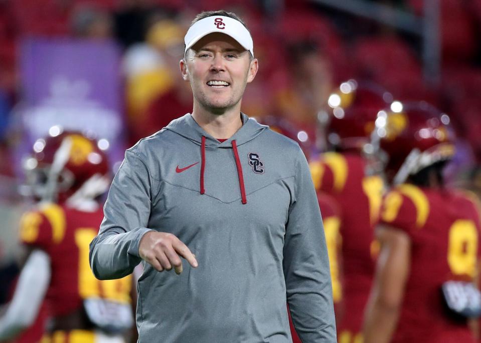 USC coach Lincoln Riley directs pre-game warmups before the Trojans face off against Fresno State