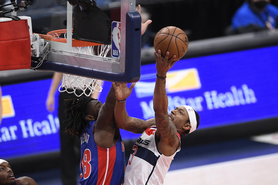 Washington Wizards guard Bradley Beal (3) goes to the basket against Detroit Pistons center Isaiah Stewart, left, during the first half of an NBA basketball game, Saturday, April 17, 2021, in Washington. (AP Photo/Nick Wass)