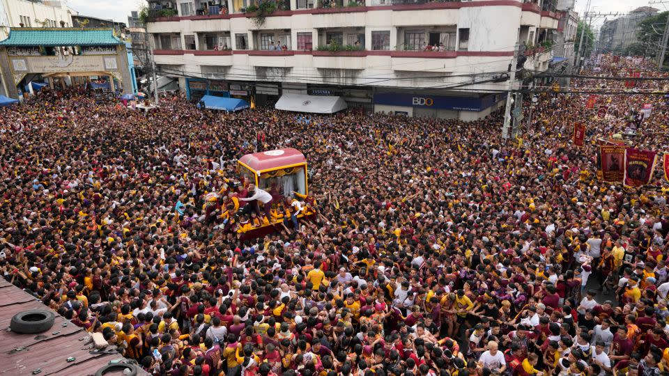 A sea of devotees dressed in maroon and red floods central Manila to venerate the centuries-old statue of Jesus. - Aaron Favila/AP