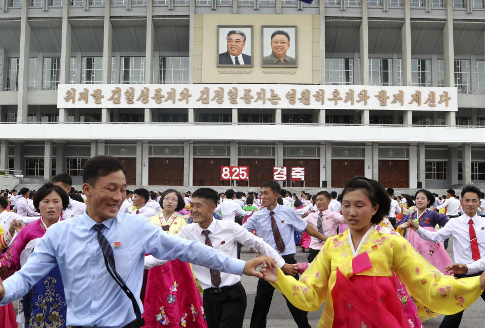 Youth and students hold dancing party for celebrating the 62nd anniversary of their late leader Kim Jong Il's first field guidance for the revolutionary armed forces, at the plaza of the Pyongyang Indoor Stadium in Pyongyang, North Korea Thursday, Aug. 25, 2022. (AP Photo/Cha Song Ho)