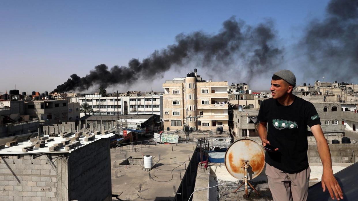 PHOTO: A man looks on as thick, black smoke rises from a fire in a building caused by Israeli bombardment in Rafah in the southern Gaza Strip, May 10, 2024. (AFP via Getty Images)