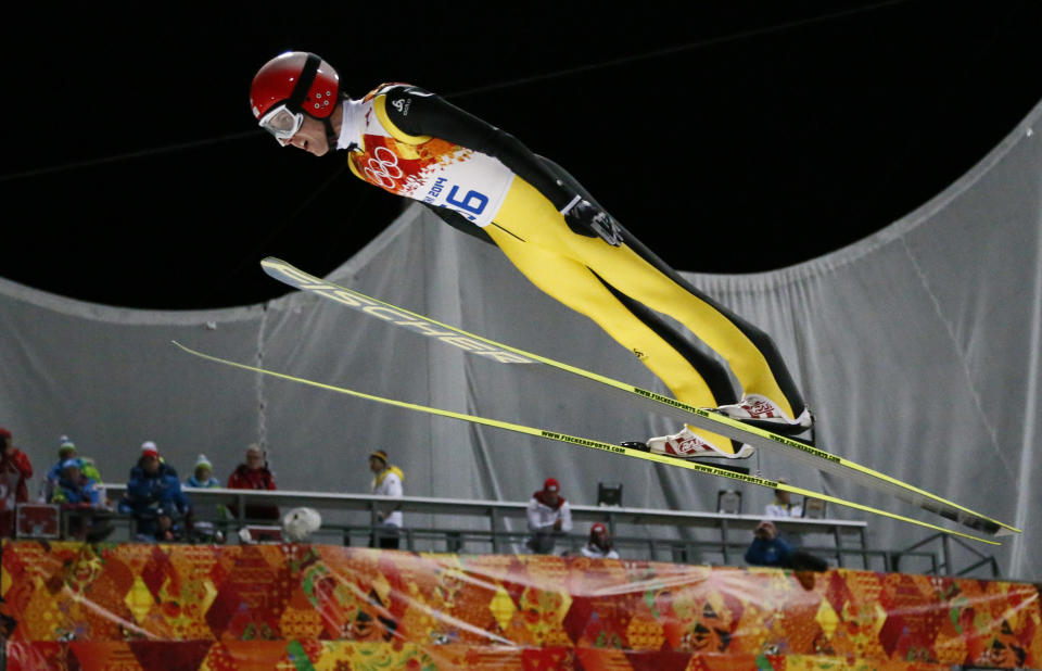 Switzerland's Simon Ammann makes an attempt during the ski jumping large hill qualification at the 2014 Winter Olympics, Friday, Feb. 14, 2014, in Krasnaya Polyana, Russia. (AP Photo/Dmitry Lovetsky)