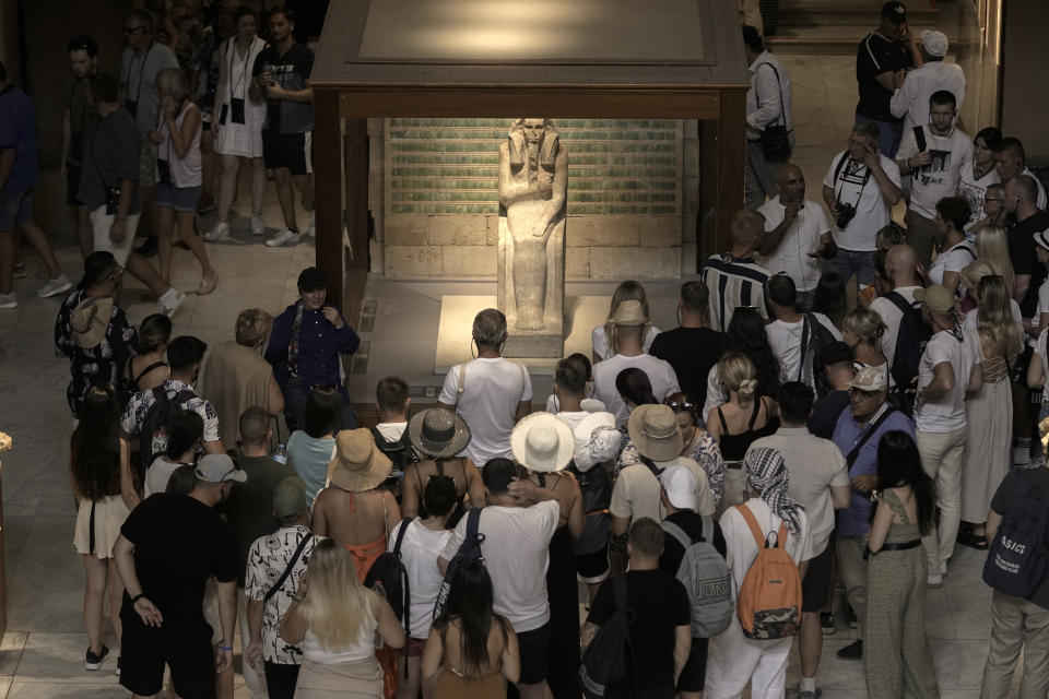 Hundreds of tourists surround the statue of Djoser, at the Egyptian museum in Cairo, Egypt, Wednesday, Sept. 27, 2023. The country is aiming at reaching 30 million visitors by 2028, as its once-thriving tourism sector has begun to recover from the fallout of the coronavirus pandemic and the grinding war in Europe, Egypt's Tourism and Antiquities Minister Ahmed Issa said during an interview with the Associated Press. (AP Photo/Amr Nabil)