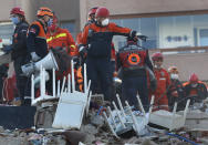 Members of rescue services search for survivors in the debris of a collapsed building in Izmir, Turkey, Saturday, Oct. 31, 2020. Rescue teams on Saturday ploughed through concrete blocs and debris of eight collapsed buildings in Turkey's third largest city in search of survivors of a powerful earthquake that struck Turkey's Aegean coast and north of the Greek island of Samos, killing dozens Hundreds of others were injured. (AP Photo/Darko Bandic)