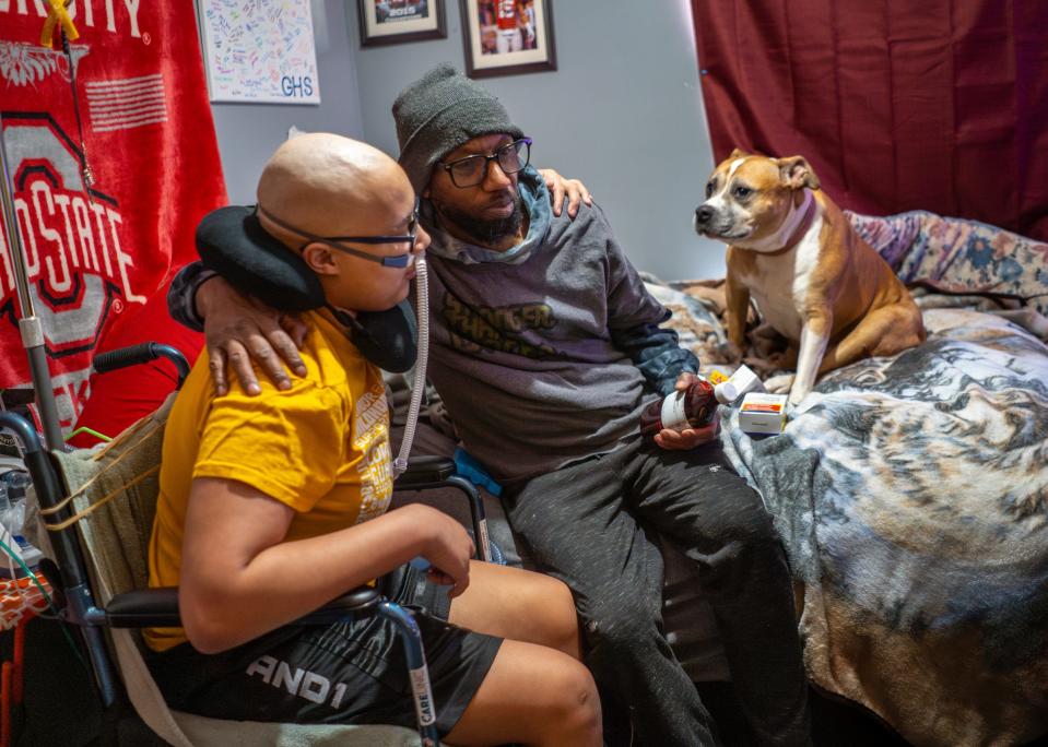 Tim Hawthorne, 51, of Gaylord, sits with his son Trae, 15, in his bedroom as their dog Pearl watches on Wednesday, March 27, 2024.