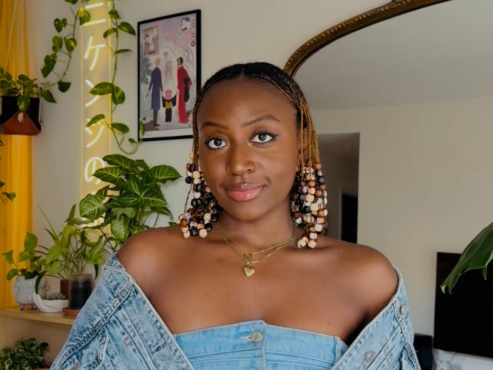 A woman wearing a denim top and jacket.