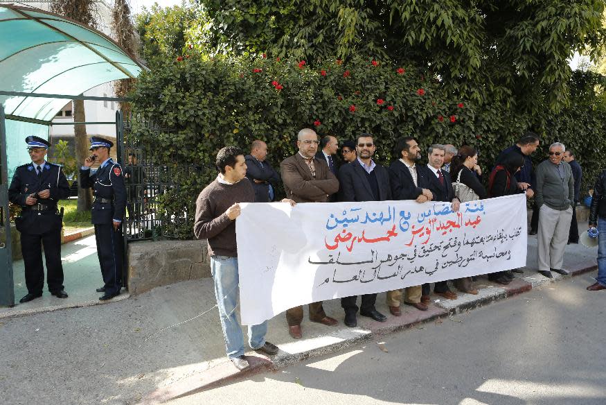 People display a banner outside a courthouse in Rabat, Morocco, where a corruption trial took place against two civil servants for leaking government documents, Friday, March 21, 2014. The Islamist party that dominated elections that year ran on an anti-corruption campaign and after taking office in June 2012, announced an investigation into leaked documents that allegedly showed that the former finance minister and the national treasurer authorized salary bonuses for each other. In Friday’s verdict on the case of the two former Finance Ministry employees, Abdelmajid Alouiz was found guilty and fined $250 with a two month suspended sentence while Mohammed Reda was acquitted on the charge of leaking government documents. Banner reads in blue: Support Committee of Ingeners. In black: Open an inquiry into the disappearance of State assets. (AP Photo/Abdeljalil Bounhar)