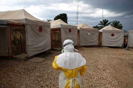FILE PHOTO: A health worker wearing Ebola protection gear, walks before entering the Biosecure Emergency Care Units at the Alima Ebola treatment centre in Beni