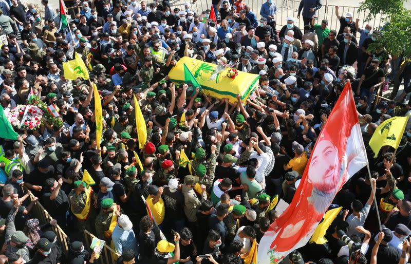 People carry the coffin of Mohamed Tahan, who was killed at the border fence with Israel yesterday, during his funeral in Adloun