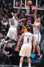 BROOKLYN, NY - FEBRUARY 5: Kobe Bryant #24 of the Los Angeles Lakers dunks against Gerald Wallace #45 and Kris Humphries #43 of the Brooklyn Nets on February 5, 2013 at the Barclays Center in the Brooklyn borough of New York City. NOTE TO USER: User expressly acknowledges and agrees that, by downloading and or using this photograph, User is consenting to the terms and conditions of the Getty Images License Agreement. Mandatory Copyright Notice: Copyright 2013 NBAE (Photo by Andrew D. Bernstein/NBAE via Getty Images)