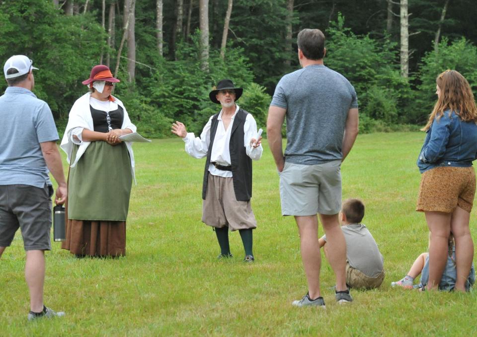 Dressed in 1600s attire, Rebecca Lambert, of Norwell, second from left, and Jim Stetson, of Westboro, center, president of the Stetson Kindred of America, explain what life in the 17th century was like for Norwell's first settler, Cornet Robert Stetson, during Stetson Heritage Day in Norwell, Saturday, Aug. 19, 2023.