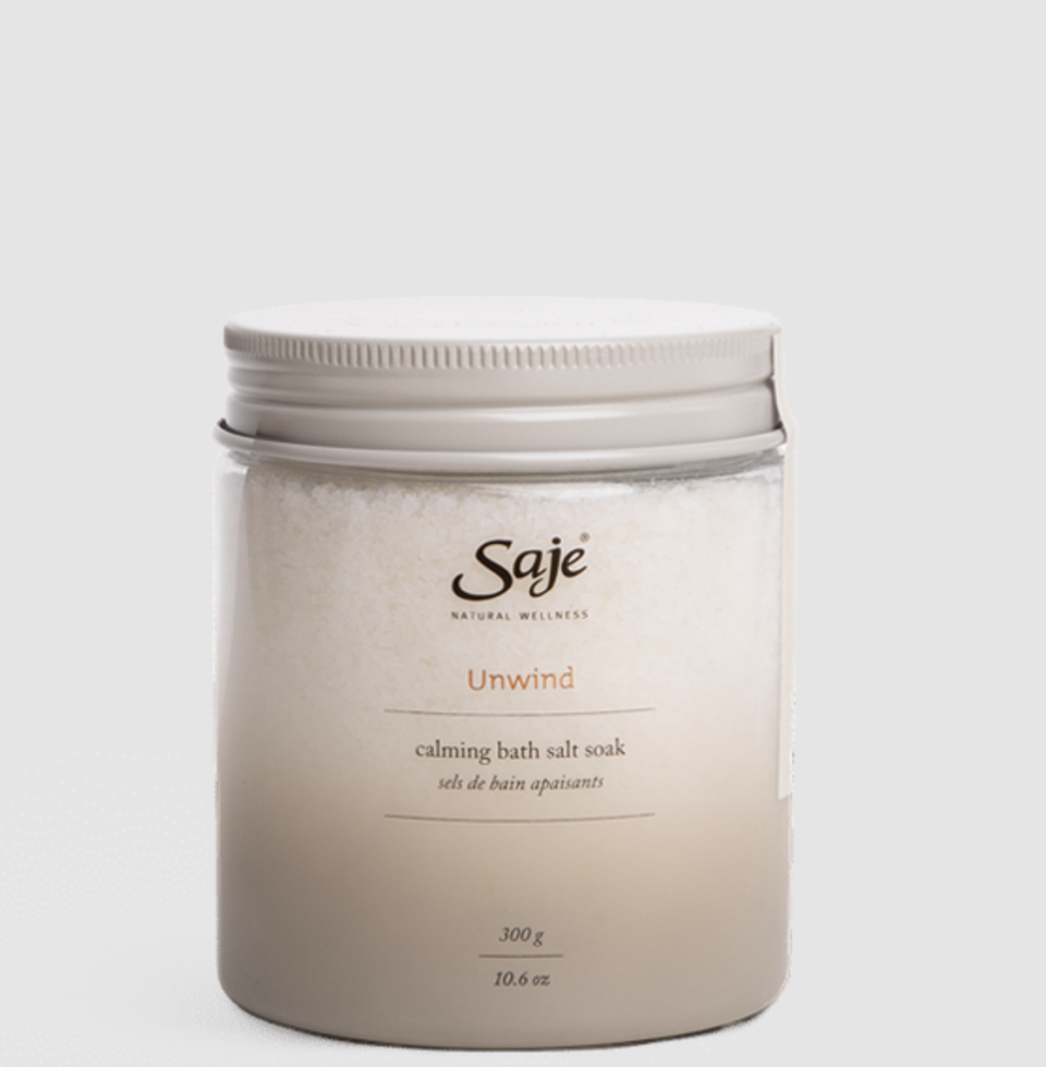 Unwind Calming Bath Soak from sage on grey background (photo via Saje)