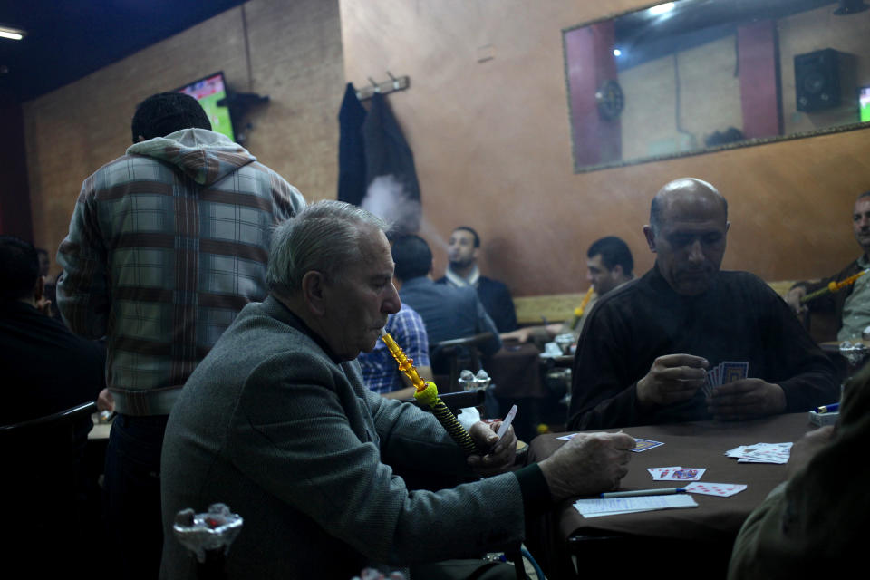 In this Thursday, Jan. 23, 2014 photo, customers smoke water pipes at a coffee shop in Amman, Jordan. In Jordan, a country where smoking is so popular that motorists can be seen puffing away on miniature water pipes in traffic, the kingdom’s government now wants to enforce a Western-style smoking ban in restaurants, cafes and other public places. (AP Photo/Mohammad Hannon)