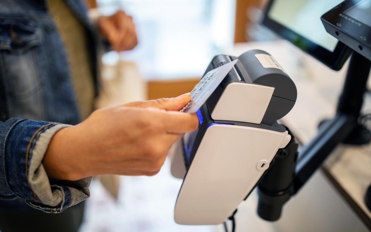 woman using credit card for contactless payment at checkout